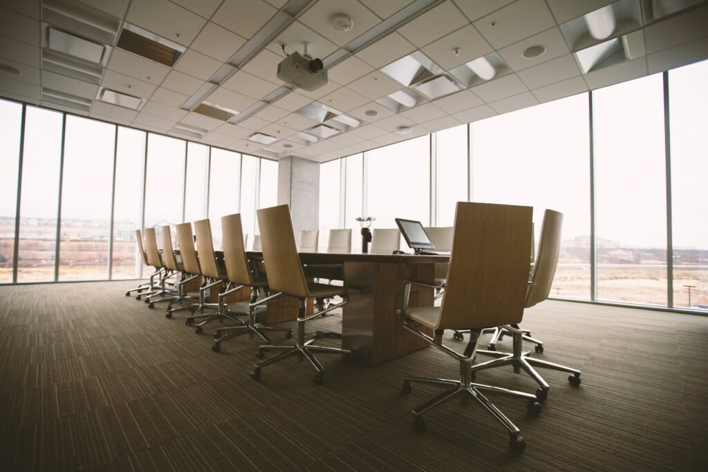 Empty glass-walled boardroom with city view