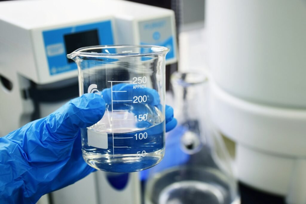 Laboratory glassware held in a gloved hand